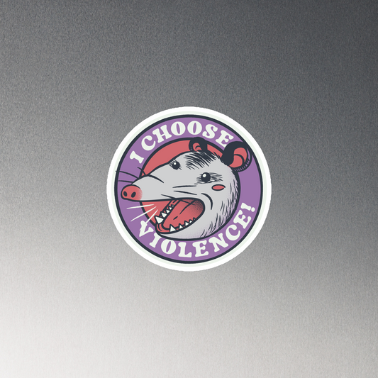 A circular design featuring an opossum with an open mouth showing sharp teeth, set against a red and purple background. Surrounding the animal, the text reads 'I Choose Violence!' in bold, white letters. The opossum has a somewhat comical yet aggressive expression. The design has an edgy, cartoon-like style, suitable for various products like t-shirts and stickers.