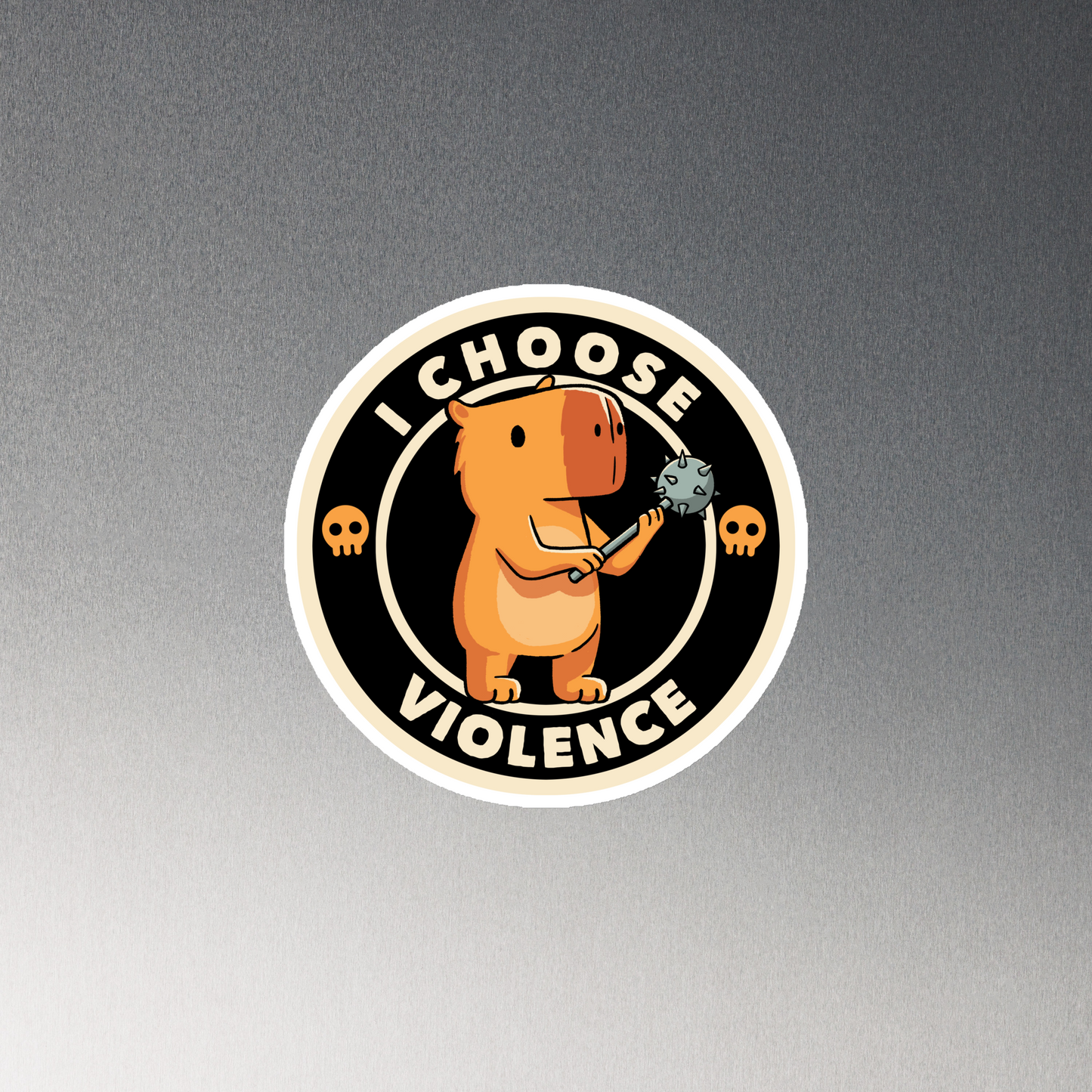 A cute, cartoonish burnt yellow capybara stands holding a spiked mace with a determined expression. Surrounding it is a circular design with the text 'I CHOOSE VIOLENCE' and two small skulls on either side, giving it a humorous yet ironic tone.