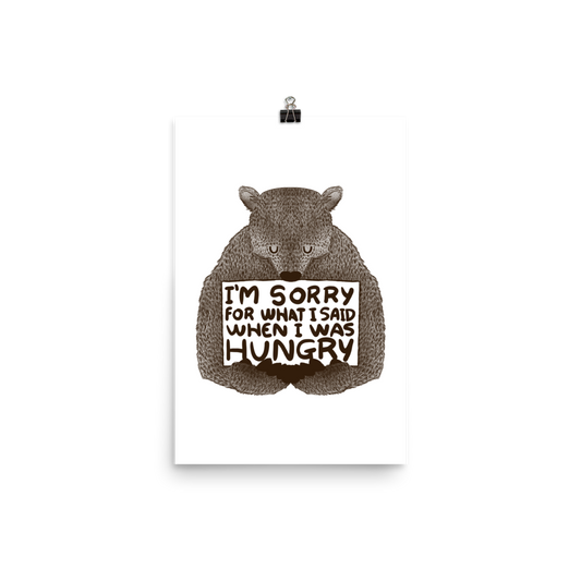 The image shows a humorous, detailed illustration of a bear, drawn in a hand-drawn style, holding a sign that reads 'I'm sorry for what I said when I was hungry.' The bear appears to be apologizing in a comical, endearing manner, making it a relatable and light-hearted design.