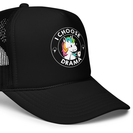 A cartoon unicorn with rainbow-colored mane holds a cup of tea and a heart, encircled by the words 'I Choose Drama'. Two small clouds with lightning bolts flank the unicorn, adding a playful yet slightly edgy vibe. The design is bold and whimsical with a pop-art influence.