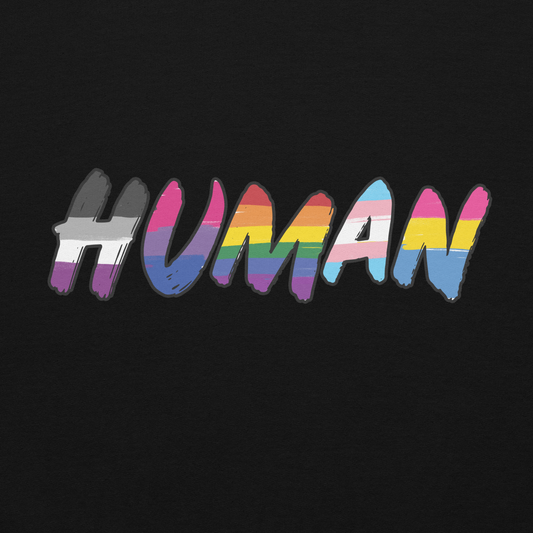 The image displays the word 'HUMAN' in bold, capitalized letters filled with colorful pride flag patterns. The colors within the letters represent different LGBTQ+ pride flags, symbolizing inclusivity and diversity. The background is solid black, which makes the colorful patterns stand out more vibrantly.