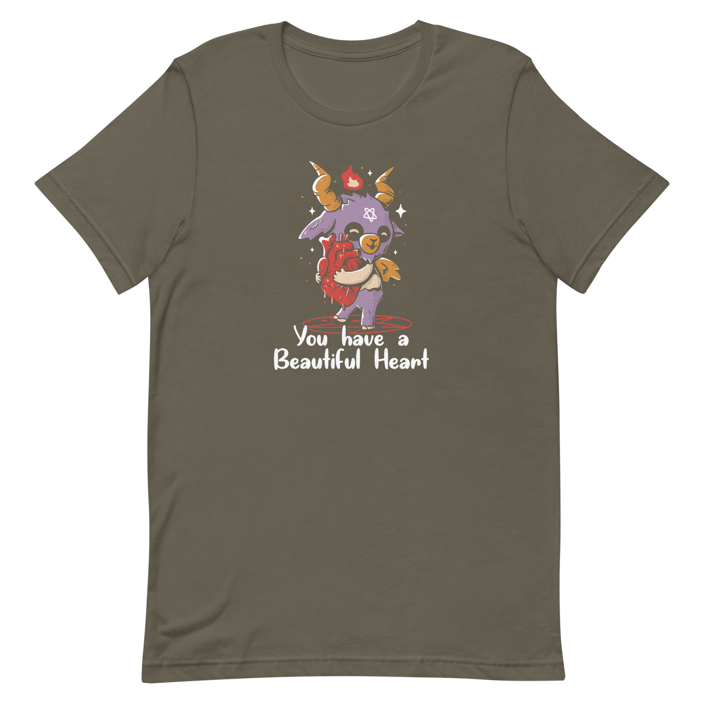 The design features a cute, cartoonish, anthropomorphic goat with big horns and a flame above its head, standing on a red pentagram. The goat has a star on its forehead and is hugging a large, anatomically correct human heart. The text below reads, 'You have a Beautiful Heart'. The image combines elements of occult symbolism with a playful, endearing aesthetic.
