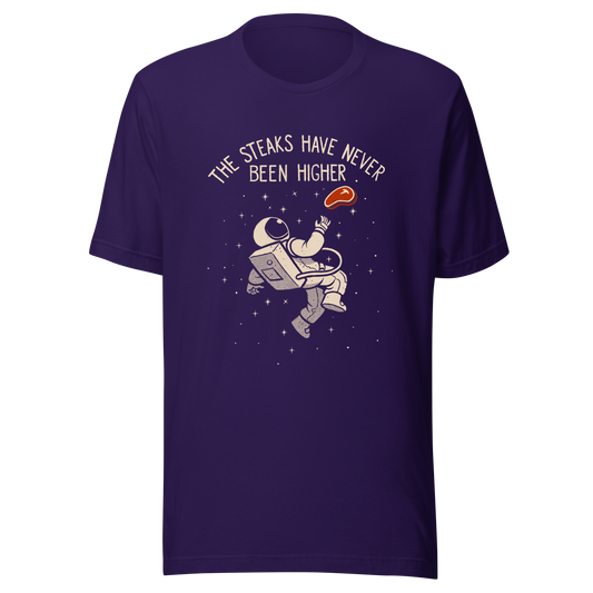 An astronaut floating through space with a small steak in front of him, paired with the phrase ‘The Steaks Have Never Been Higher’. A playful and humorous design that blends space exploration with a clever visual pun. Perfect for fans of witty wordplay and quirky art.