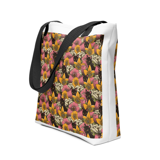 The image features a repeating pattern of colorful flowers in pink, yellow, and cream hues with lush green foliage. Interspersed among the flowers are playful black cats with bright eyes. The design has a whimsical and vibrant feel, ideal for various products like t-shirts, stickers, coffee cups, and skateboards. The style is reminiscent of traditional floral art blended with playful elements of animal decor.