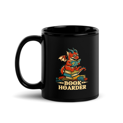 Perched atop his treasure trove of books, this red nerdy dragon is ready to devour epic adventures, magic tales, and fantasy worlds. The words 'BOOK HOARDER' are placed at the bottom of the design.