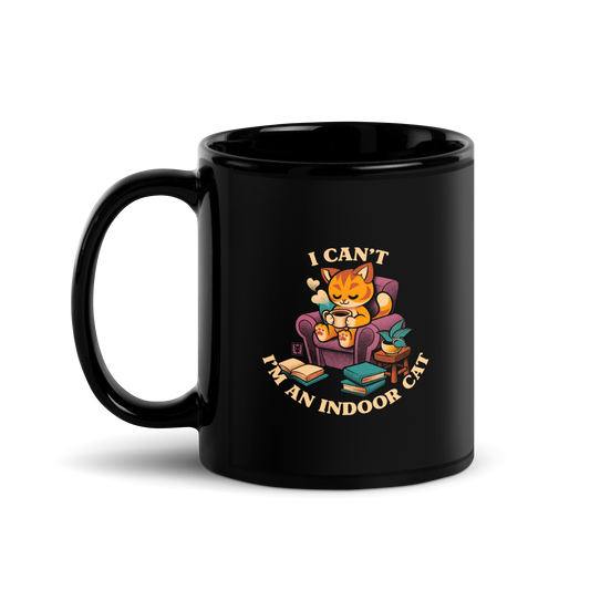 This cozy design features a contented orange cat sipping coffee in a comfy chair, surrounded by books and plants. The following message encircles the design: I CAN'T I'M AN INDOOR CAT.
