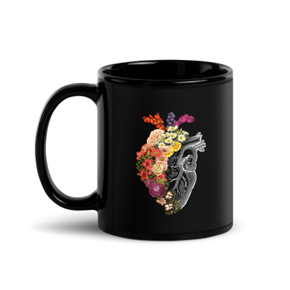 The design is an intricate and anatomical drawing of a human heart on a black background. The left side of the heart morphs into a vibrant assortment of colorful flowers, including roses, daisies, and other blooming blossoms, creating a striking contrast between the realistic and the surreal, symbolizing the harmony between nature and humanity.