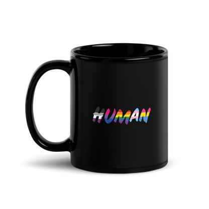 The image displays the word 'HUMAN' in bold, capitalized letters filled with colorful pride flag patterns. The colors within the letters represent different LGBTQ+ pride flags, symbolizing inclusivity and diversity. The background is solid black, which makes the colorful patterns stand out more vibrantly.