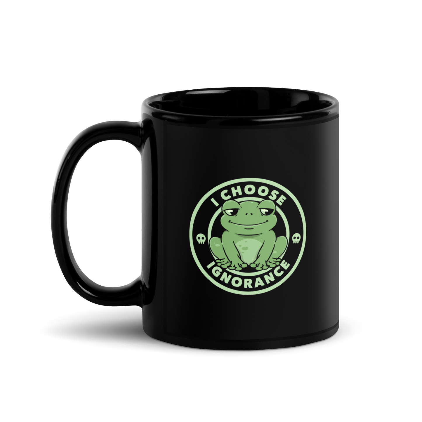 The image shows a cartoonish green frog with a sly smile, sitting with legs splayed out. Around it, the phrase 'I CHOOSE IGNORANCE' is written in bold letters. Two small skull designs are included, one on each side of the frog. The style is playful and ironic, blending elements of humor and rebellion.