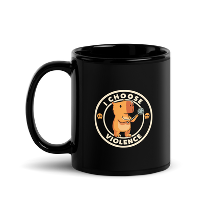 A cute, cartoonish burnt yellow capybara stands holding a spiked mace with a determined expression. Surrounding it is a circular design with the text 'I CHOOSE VIOLENCE' and two small skulls on either side, giving it a humorous yet ironic tone.