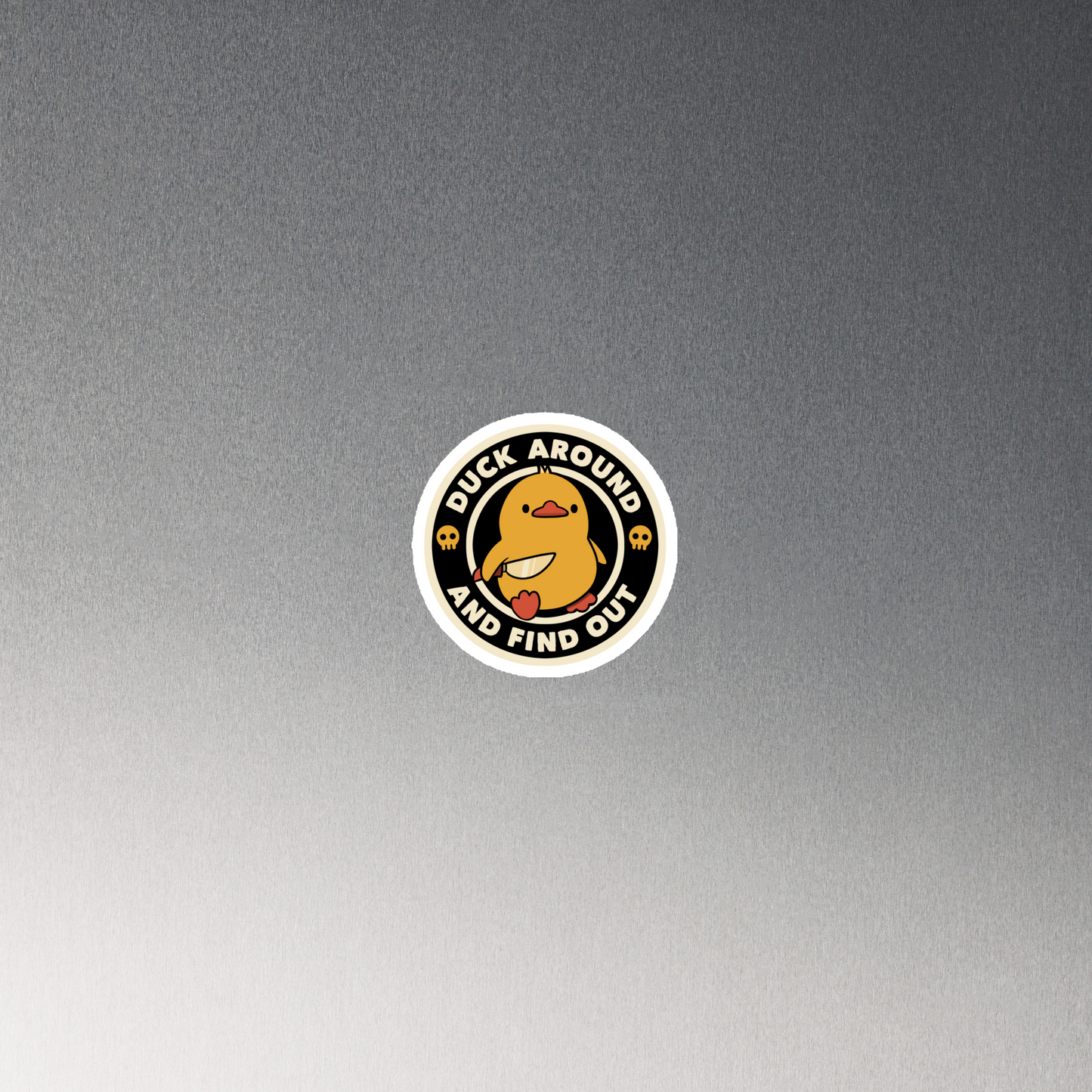 A cute yellow duck holding a small knife, around it the text "Duck Around And Find Out". An art that mixes humor with the temperament of ducks.