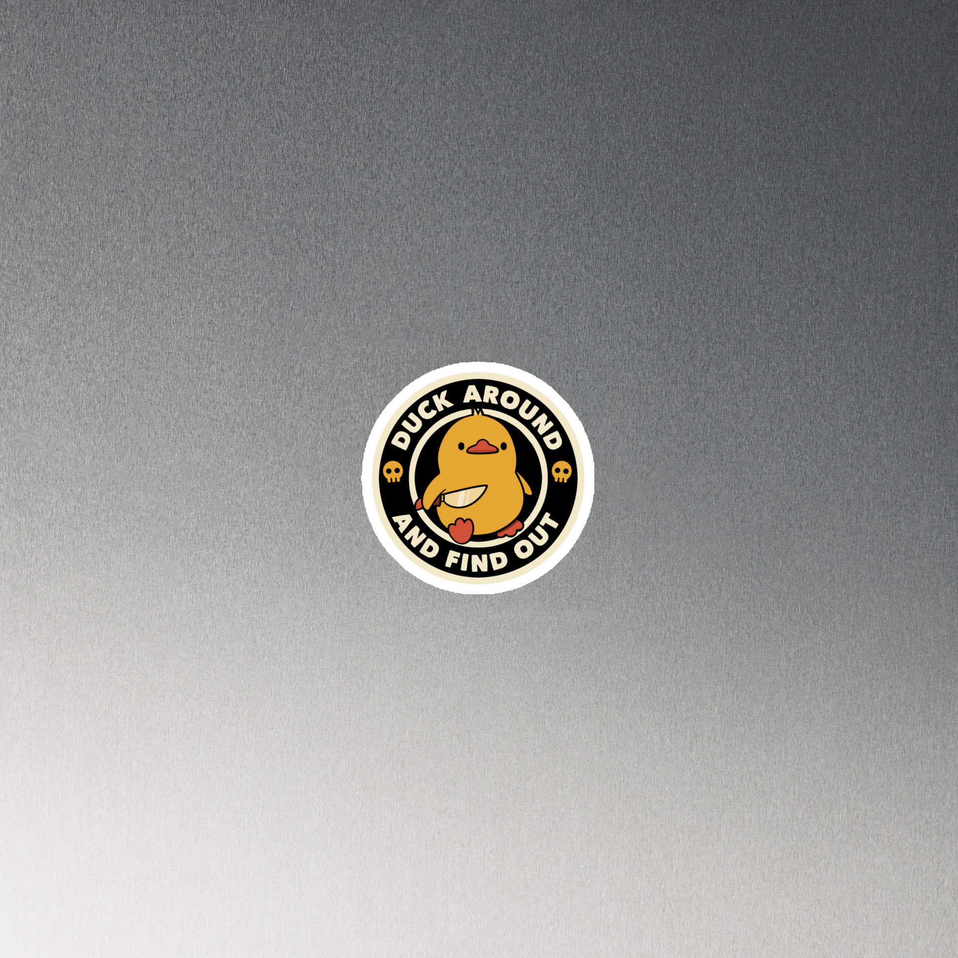 A cute yellow duck holding a small knife, around it the text "Duck Around And Find Out". An art that mixes humor with the temperament of ducks.