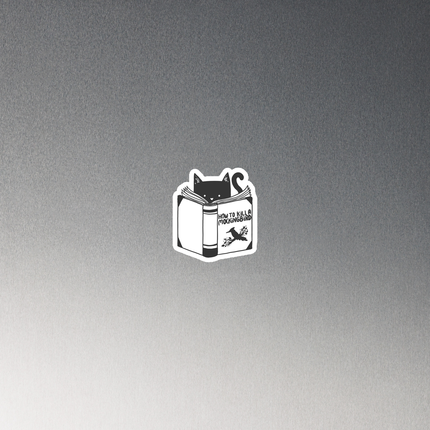 A black and white illustration features a cat peeking over an open book titled 'How to Kill a Mockingbird,' playfully altering the classic novel's title. The cat has a heart-shaped nose and simple, cute facial features. The design is whimsical and ironic, combining classic literature with a humorous twist.