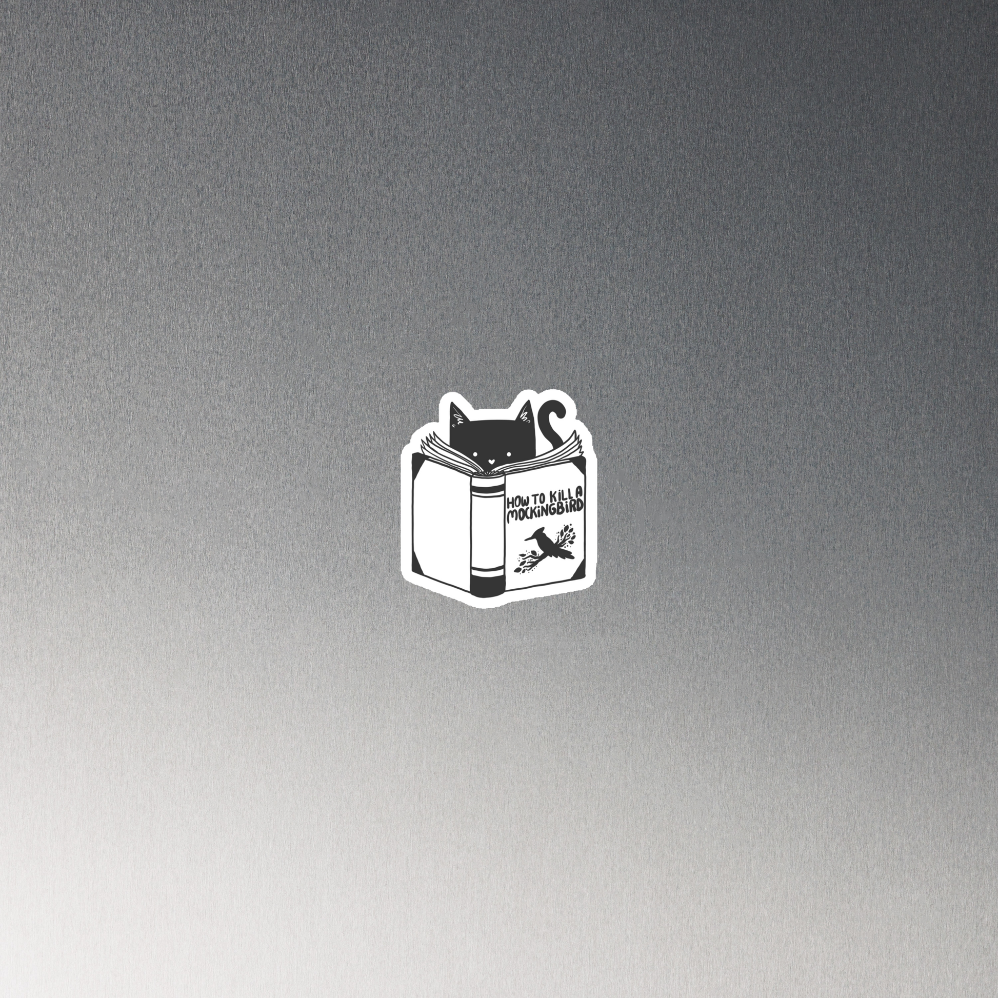 A black and white illustration features a cat peeking over an open book titled 'How to Kill a Mockingbird,' playfully altering the classic novel's title. The cat has a heart-shaped nose and simple, cute facial features. The design is whimsical and ironic, combining classic literature with a humorous twist.