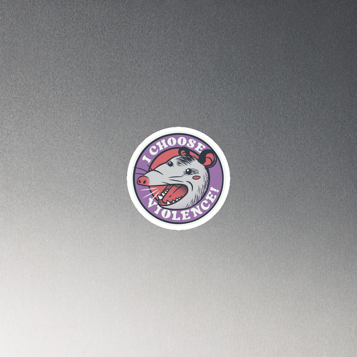 A circular design featuring an opossum with an open mouth showing sharp teeth, set against a red and purple background. Surrounding the animal, the text reads 'I Choose Violence!' in bold, white letters. The opossum has a somewhat comical yet aggressive expression. The design has an edgy, cartoon-like style, suitable for various products like t-shirts and stickers.