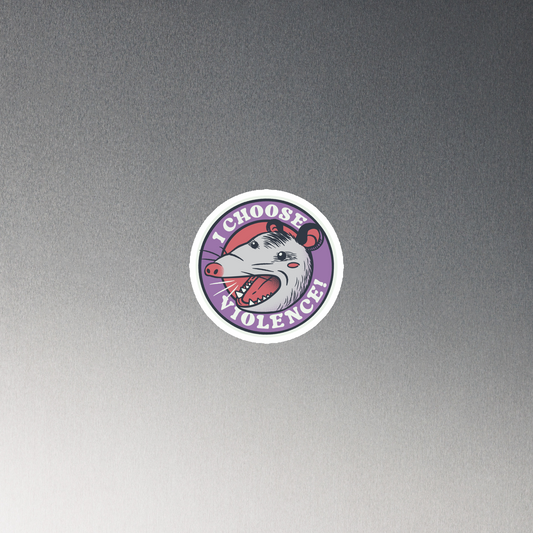 A circular design featuring an opossum with an open mouth showing sharp teeth, set against a red and purple background. Surrounding the animal, the text reads 'I Choose Violence!' in bold, white letters. The opossum has a somewhat comical yet aggressive expression. The design has an edgy, cartoon-like style, suitable for various products like t-shirts and stickers.