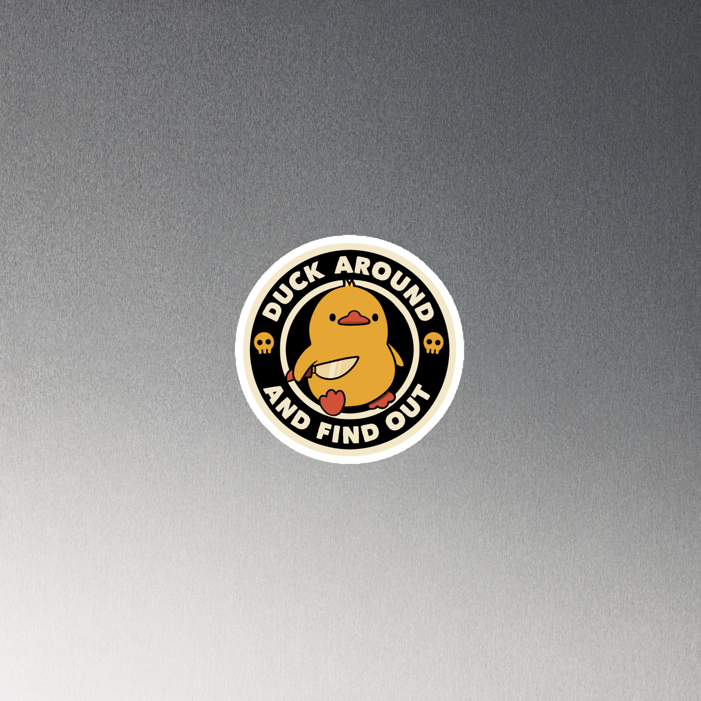 A cute yellow duck holding a small knife, around it the text "Duck Around And Find Out". An art that mixes humor with the temperament of ducks.