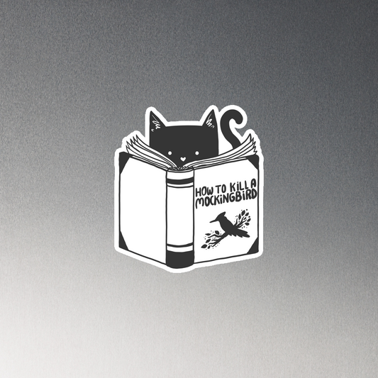 A black and white illustration features a cat peeking over an open book titled 'How to Kill a Mockingbird,' playfully altering the classic novel's title. The cat has a heart-shaped nose and simple, cute facial features. The design is whimsical and ironic, combining classic literature with a humorous twist.