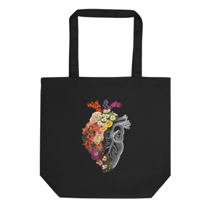 The design is an intricate and anatomical drawing of a human heart on a black background. The left side of the heart morphs into a vibrant assortment of colorful flowers, including roses, daisies, and other blooming blossoms, creating a striking contrast between the realistic and the surreal, symbolizing the harmony between nature and humanity.