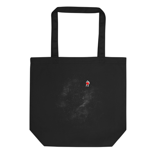 The image depicts a lone astronaut floating in outer space, seemingly sitting on nothing while holding a large, bright red heart. The background is a starry expanse of black, suggesting the vastness and cold emptiness of space. The stark contrast between the dark space and the vibrant heart symbolizes love and loneliness in the cosmos.