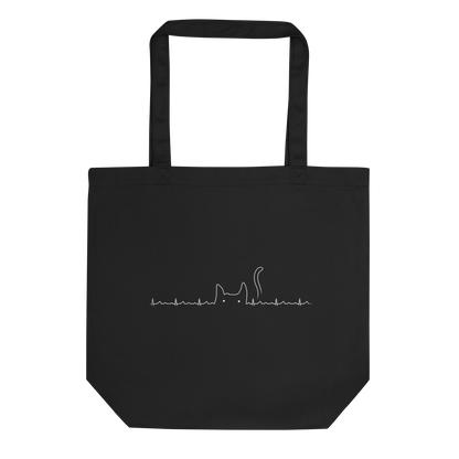 The drawing has a black background with a continuous white line depicting an electrocardiogram. Midway through, the line morphs into the minimalist outline of a cat's head with pointed ears and a tail, with two small white dots representing its eyes. The drawing creatively combines the elements of a heartbeat line and a simple cat illustration.