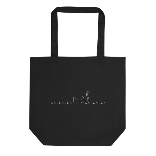 The drawing has a black background with a continuous white line depicting an electrocardiogram. Midway through, the line morphs into the minimalist outline of a cat's head with pointed ears and a tail, with two small white dots representing its eyes. The drawing creatively combines the elements of a heartbeat line and a simple cat illustration.