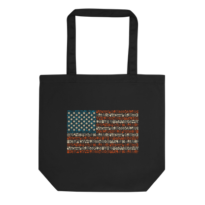 American flag illustration made entirely of retro video game icons, controllers, characters, and symbols in blue, red, and beige, arranged to form the stars and stripes.