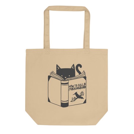 A black and white illustration features a cat peeking over an open book titled 'How to Kill a Mockingbird,' playfully altering the classic novel's title. The cat has a heart-shaped nose and simple, cute facial features. The design is whimsical and ironic, combining classic literature with a humorous twist.