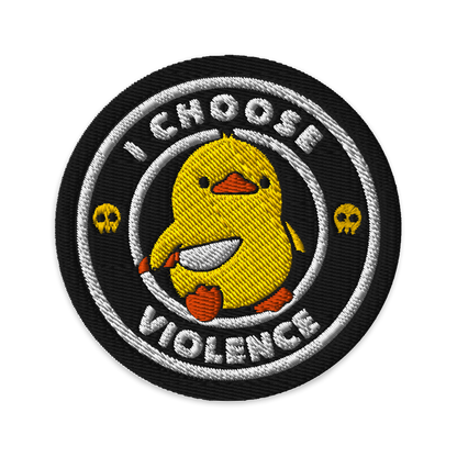The image displays a cute, cartoon-style yellow duck character holding a knife with a determined expression. The duck is centered inside a circular design with the text 'I CHOOSE FIGHT' around it. Two small skulls flanking the duck add a humorous, combative touch to the design.