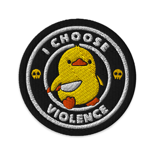 The image displays a cute, cartoon-style yellow duck character holding a knife with a determined expression. The duck is centered inside a circular design with the text 'I CHOOSE FIGHT' around it. Two small skulls flanking the duck add a humorous, combative touch to the design.