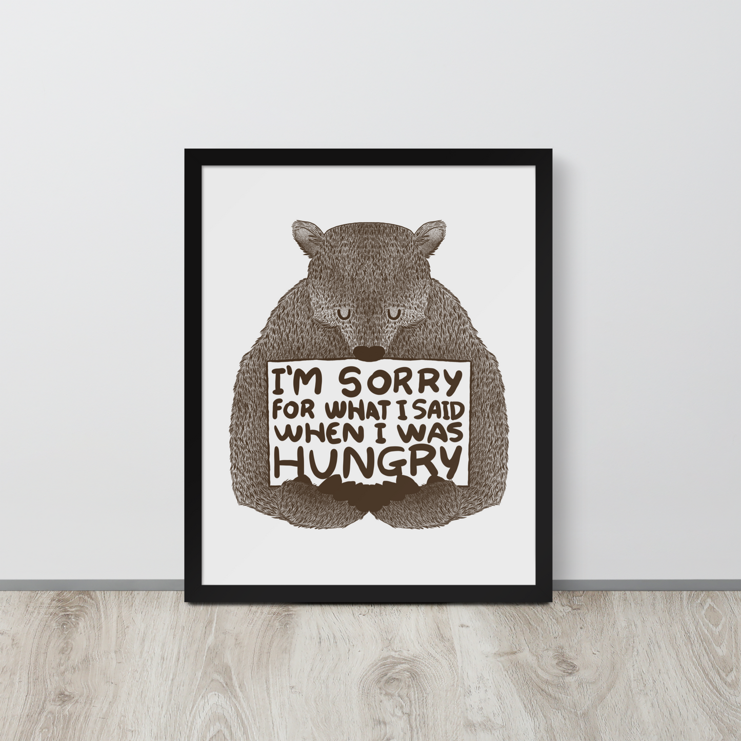 The image shows a humorous, detailed illustration of a bear, drawn in a hand-drawn style, holding a sign that reads 'I'm sorry for what I said when I was hungry.' The bear appears to be apologizing in a comical, endearing manner, making it a relatable and light-hearted design.