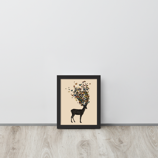 The image depicts a dark, silhouetted deer standing on a neutral background. Instead of branches, its antlers transform into a swirling cloud of vibrant, colorful butterflies that extend upwards and outward. The mix of organic and ethereal elements creates a captivating and whimsical visual contrast.