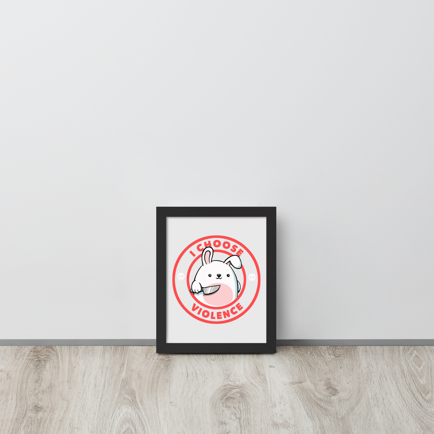A cute white cartoon bunny with a pink belly stands holding a large kitchen knife in one paw. Surrounding the bunny is a red circular border with the words 'I CHOOSE VIOLENCE'. Small skull icons are on either side of the circle. The overall tone is a mix of adorable and ironic humor.