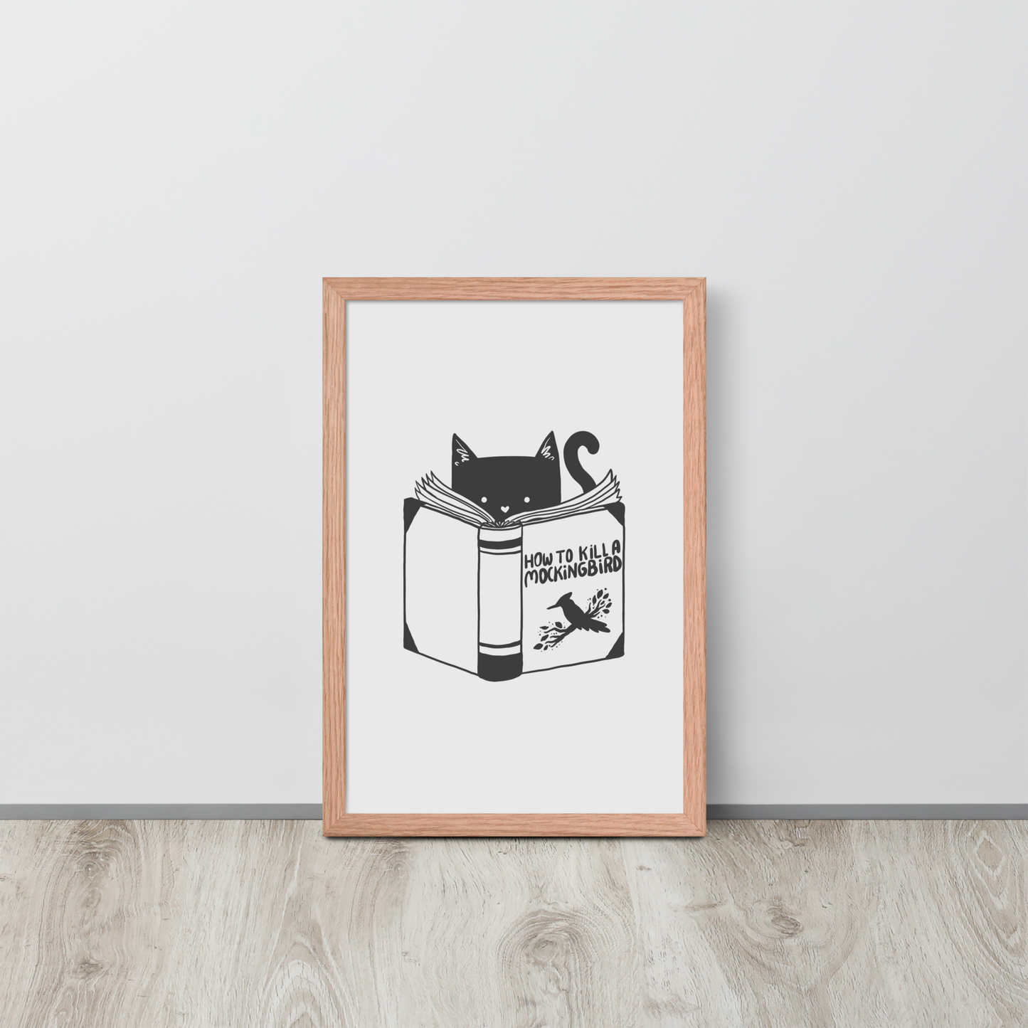 A black and white illustration features a cat peeking over an open book titled 'How to Kill a Mockingbird,' playfully altering the classic novel's title. The cat has a heart-shaped nose and simple, cute facial features. The design is whimsical and ironic, combining classic literature with a humorous twist.