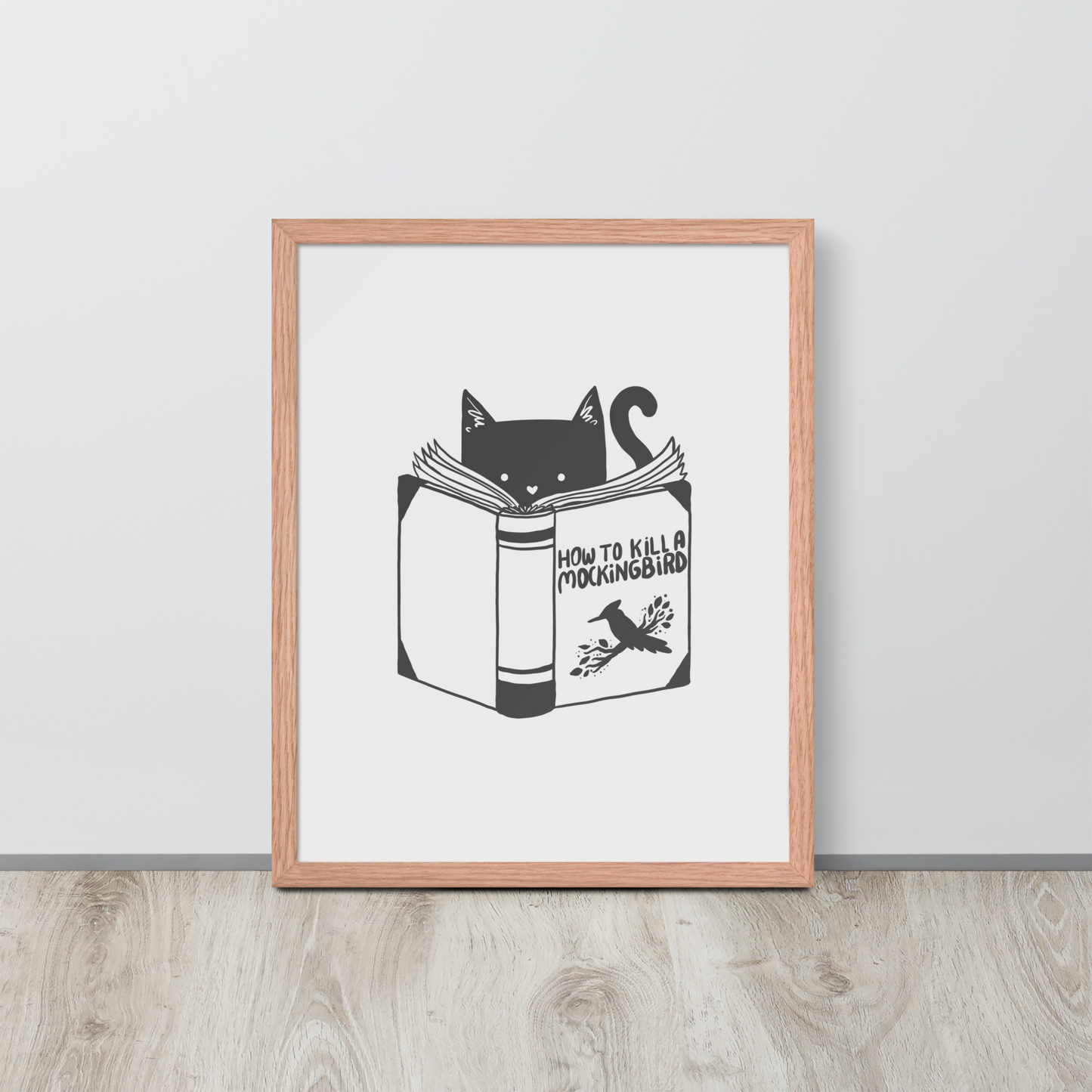 A black and white illustration features a cat peeking over an open book titled 'How to Kill a Mockingbird,' playfully altering the classic novel's title. The cat has a heart-shaped nose and simple, cute facial features. The design is whimsical and ironic, combining classic literature with a humorous twist.