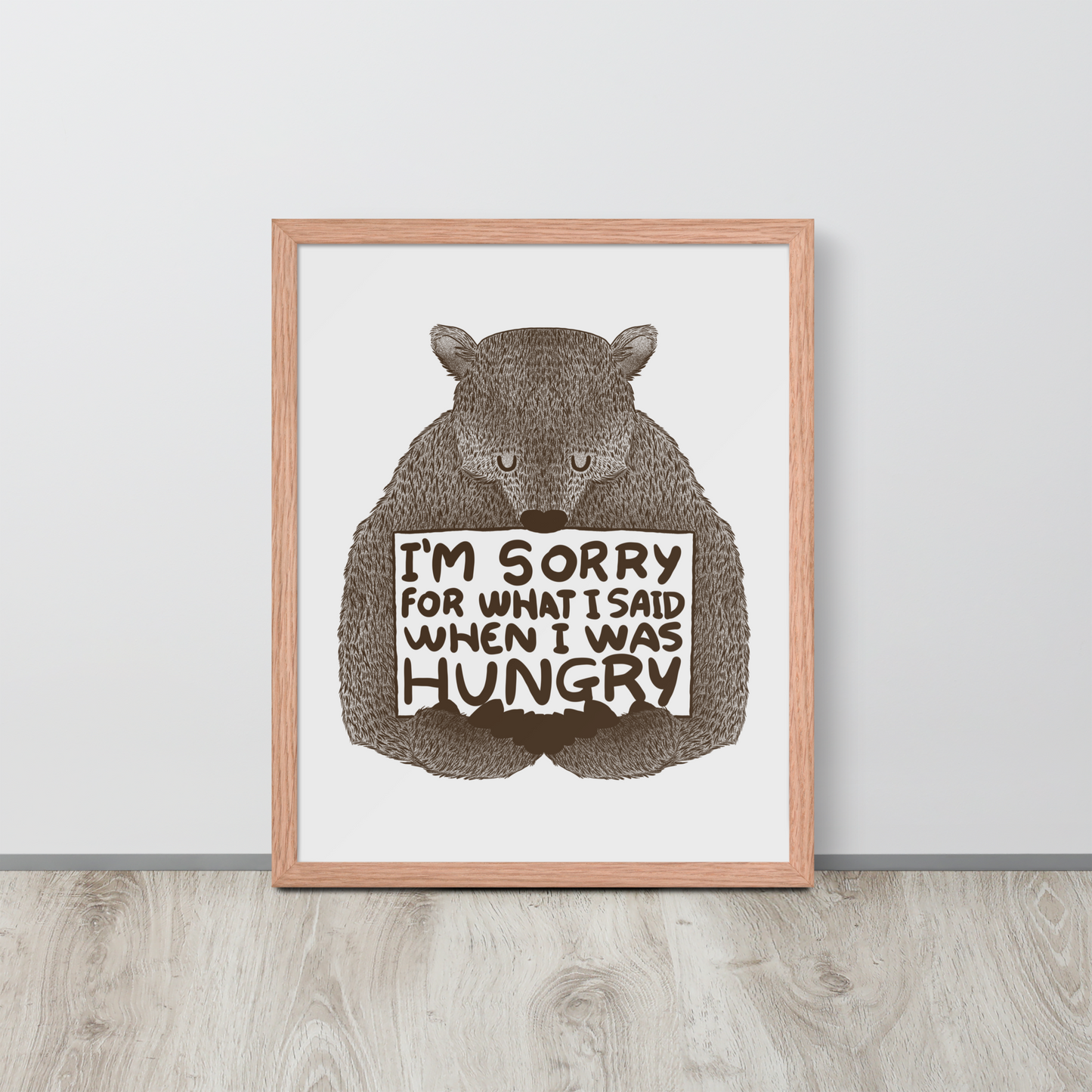 The image shows a humorous, detailed illustration of a bear, drawn in a hand-drawn style, holding a sign that reads 'I'm sorry for what I said when I was hungry.' The bear appears to be apologizing in a comical, endearing manner, making it a relatable and light-hearted design.