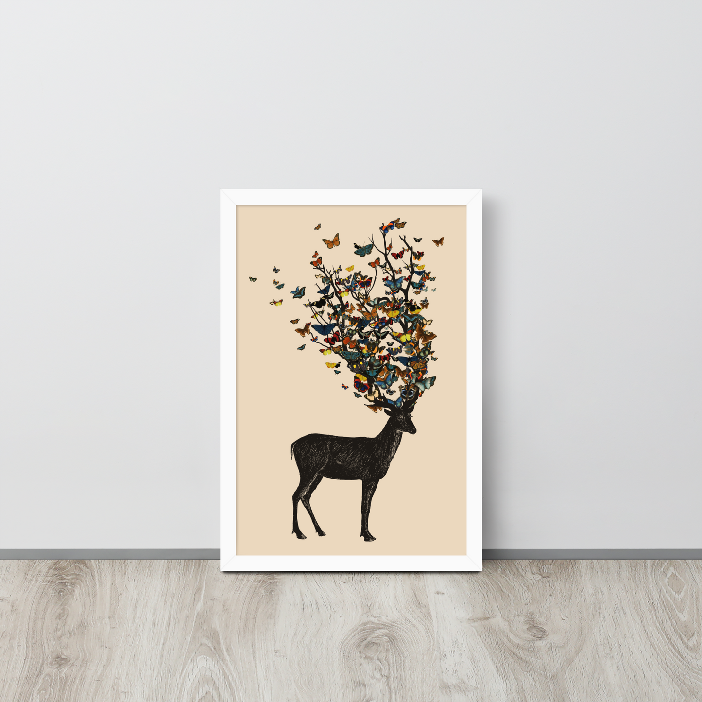 The image depicts a dark, silhouetted deer standing on a neutral background. Instead of branches, its antlers transform into a swirling cloud of vibrant, colorful butterflies that extend upwards and outward. The mix of organic and ethereal elements creates a captivating and whimsical visual contrast.