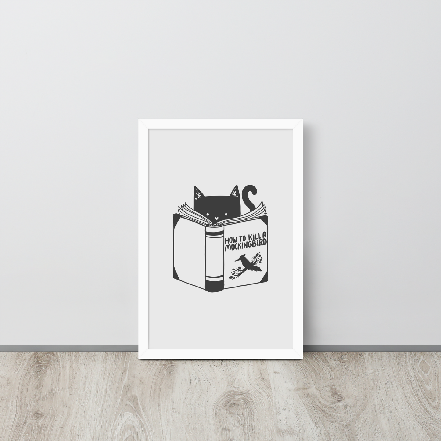 A black and white illustration features a cat peeking over an open book titled 'How to Kill a Mockingbird,' playfully altering the classic novel's title. The cat has a heart-shaped nose and simple, cute facial features. The design is whimsical and ironic, combining classic literature with a humorous twist.