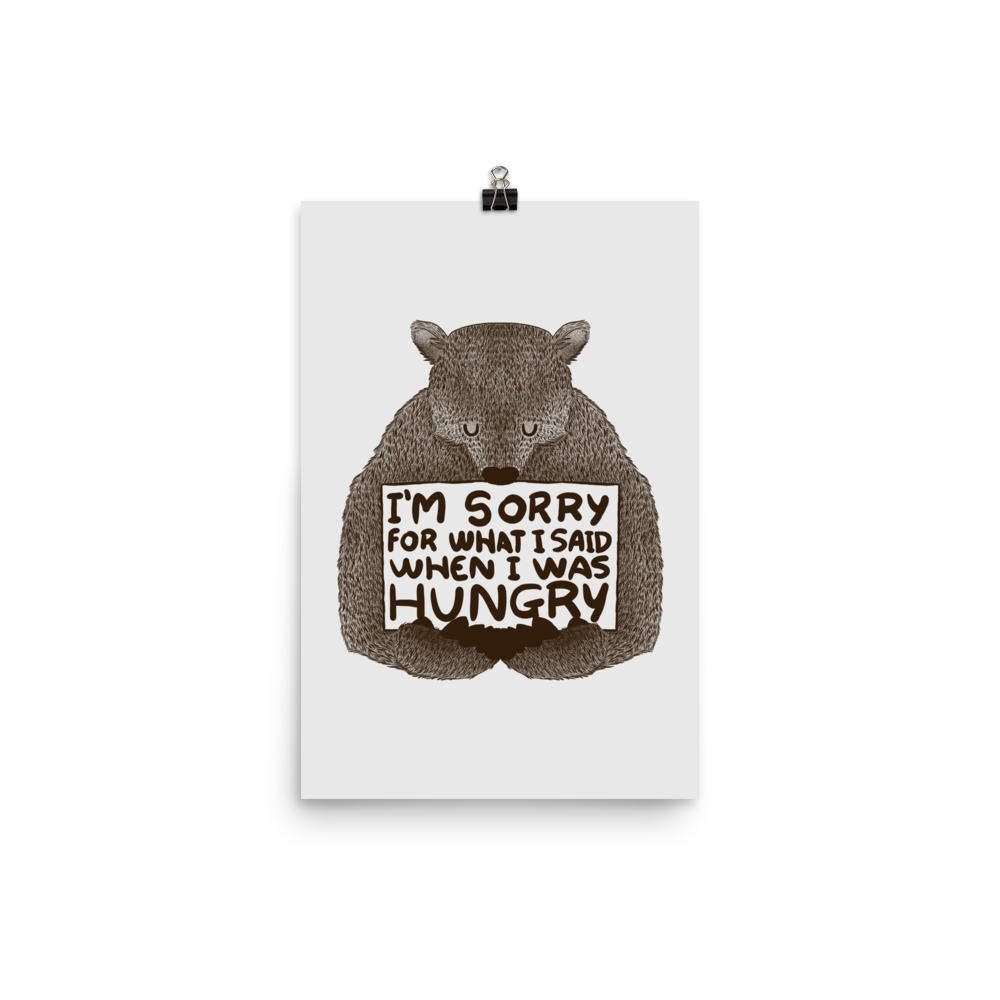 The image shows a humorous, detailed illustration of a bear, drawn in a hand-drawn style, holding a sign that reads 'I'm sorry for what I said when I was hungry.' The bear appears to be apologizing in a comical, endearing manner, making it a relatable and light-hearted design.