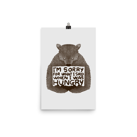 The image shows a humorous, detailed illustration of a bear, drawn in a hand-drawn style, holding a sign that reads 'I'm sorry for what I said when I was hungry.' The bear appears to be apologizing in a comical, endearing manner, making it a relatable and light-hearted design.