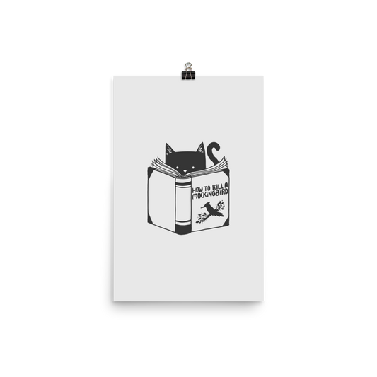 A black and white illustration features a cat peeking over an open book titled 'How to Kill a Mockingbird,' playfully altering the classic novel's title. The cat has a heart-shaped nose and simple, cute facial features. The design is whimsical and ironic, combining classic literature with a humorous twist.