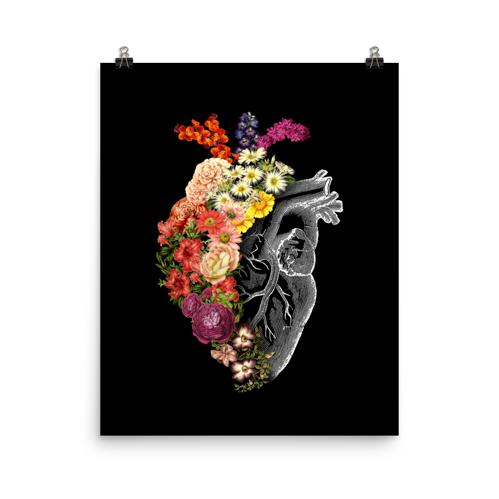The design is an intricate and anatomical drawing of a human heart on a black background. The left side of the heart morphs into a vibrant assortment of colorful flowers, including roses, daisies, and other blooming blossoms, creating a striking contrast between the realistic and the surreal, symbolizing the harmony between nature and humanity.