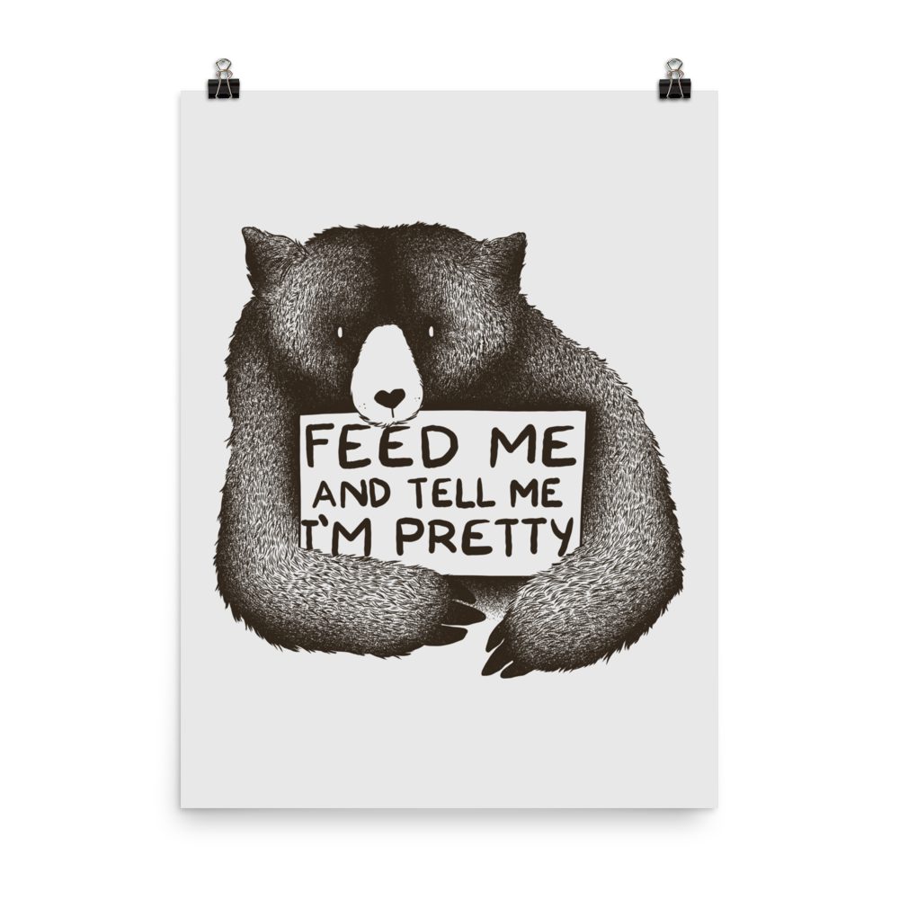 This drawing is of a cute, cartoon-style bear holding a sign with a heart-shaped nose and simple, expressive eyes. The sign reads, 'Feed me and tell me I'm pretty' in a handwritten, playful font. The bear's fur is detailed with fine, textured lines, giving it a cozy, endearing look. The drawing has a monochrome, black-and-white color scheme