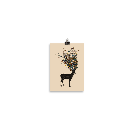 The image depicts a dark, silhouetted deer standing on a neutral background. Instead of branches, its antlers transform into a swirling cloud of vibrant, colorful butterflies that extend upwards and outward. The mix of organic and ethereal elements creates a captivating and whimsical visual contrast.