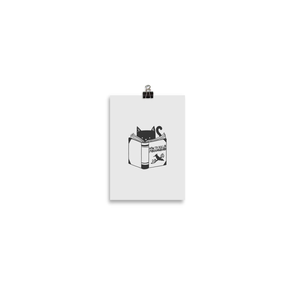 A black and white illustration features a cat peeking over an open book titled 'How to Kill a Mockingbird,' playfully altering the classic novel's title. The cat has a heart-shaped nose and simple, cute facial features. The design is whimsical and ironic, combining classic literature with a humorous twist.