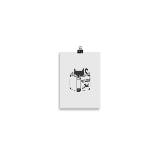 A black and white illustration features a cat peeking over an open book titled 'How to Kill a Mockingbird,' playfully altering the classic novel's title. The cat has a heart-shaped nose and simple, cute facial features. The design is whimsical and ironic, combining classic literature with a humorous twist.