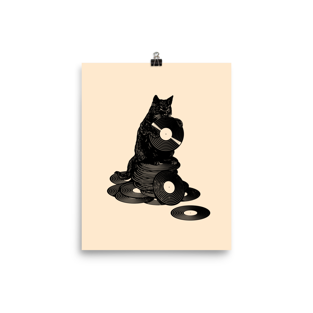 This design features a black cat cozily perched atop a stack of vinyl records, clutching one like it’s pure gold. It’s a tribute to analog lovers, feline charm, and the timeless joy of spinning a record. Perfect for music collectors, cat enthusiasts, and anyone with a nostalgic soul.