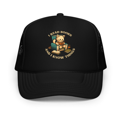An adorable cat is sitting on a stack of books encircled by the sentence "I READ BOOKS AND I KNOW THINGS". Perfect for book lovers, this design combines wit and cuteness, making it a great choice for those who love reading and cats.