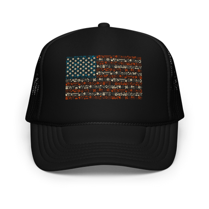 American flag illustration made entirely of retro video game icons, controllers, characters, and symbols in blue, red, and beige, arranged to form the stars and stripes.