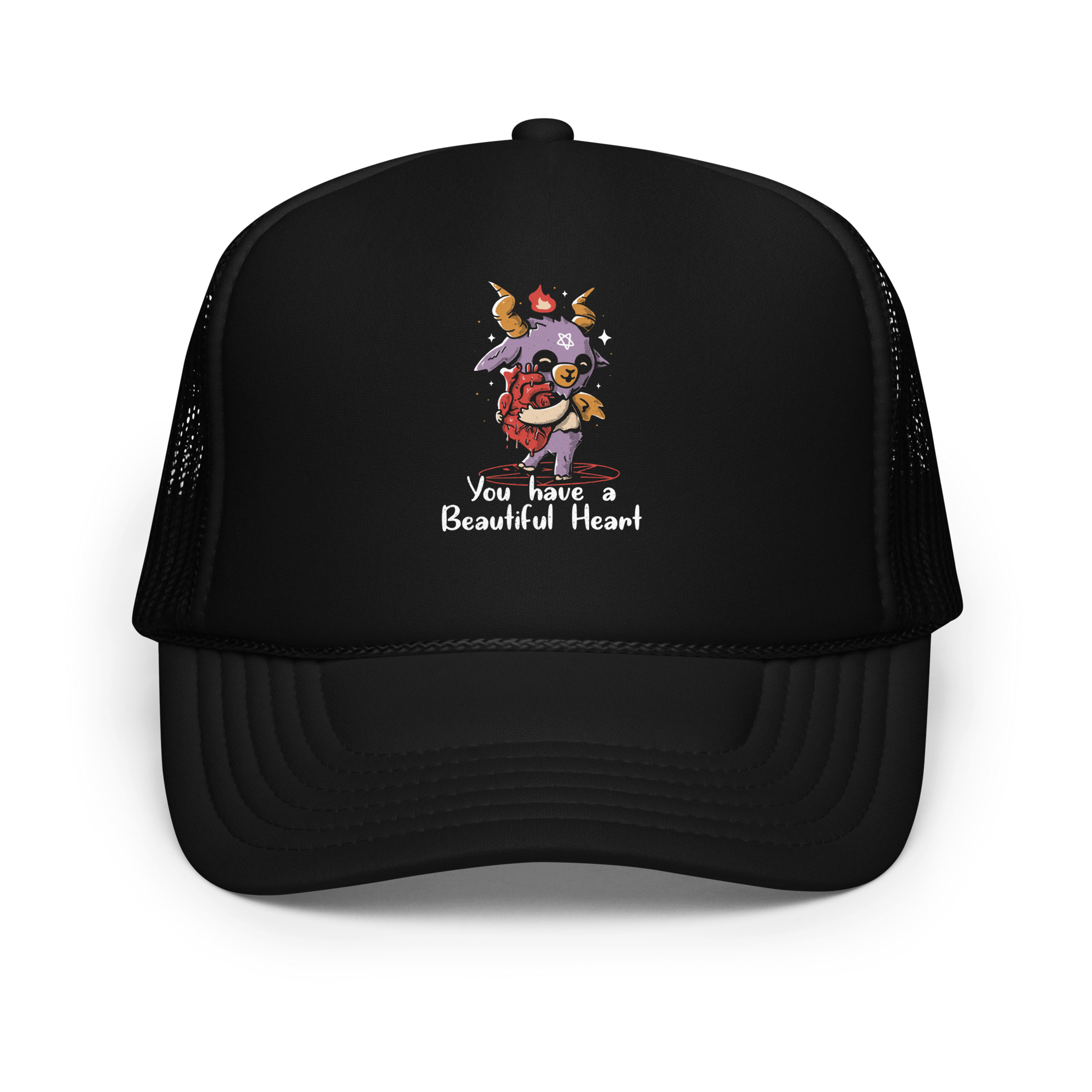 The design features a cute, cartoonish, anthropomorphic goat with big horns and a flame above its head, standing on a red pentagram. The goat has a star on its forehead and is hugging a large, anatomically correct human heart. The text below reads, 'You have a Beautiful Heart'. The image combines elements of occult symbolism with a playful, endearing aesthetic.